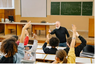 instructor in front of class with hands raised